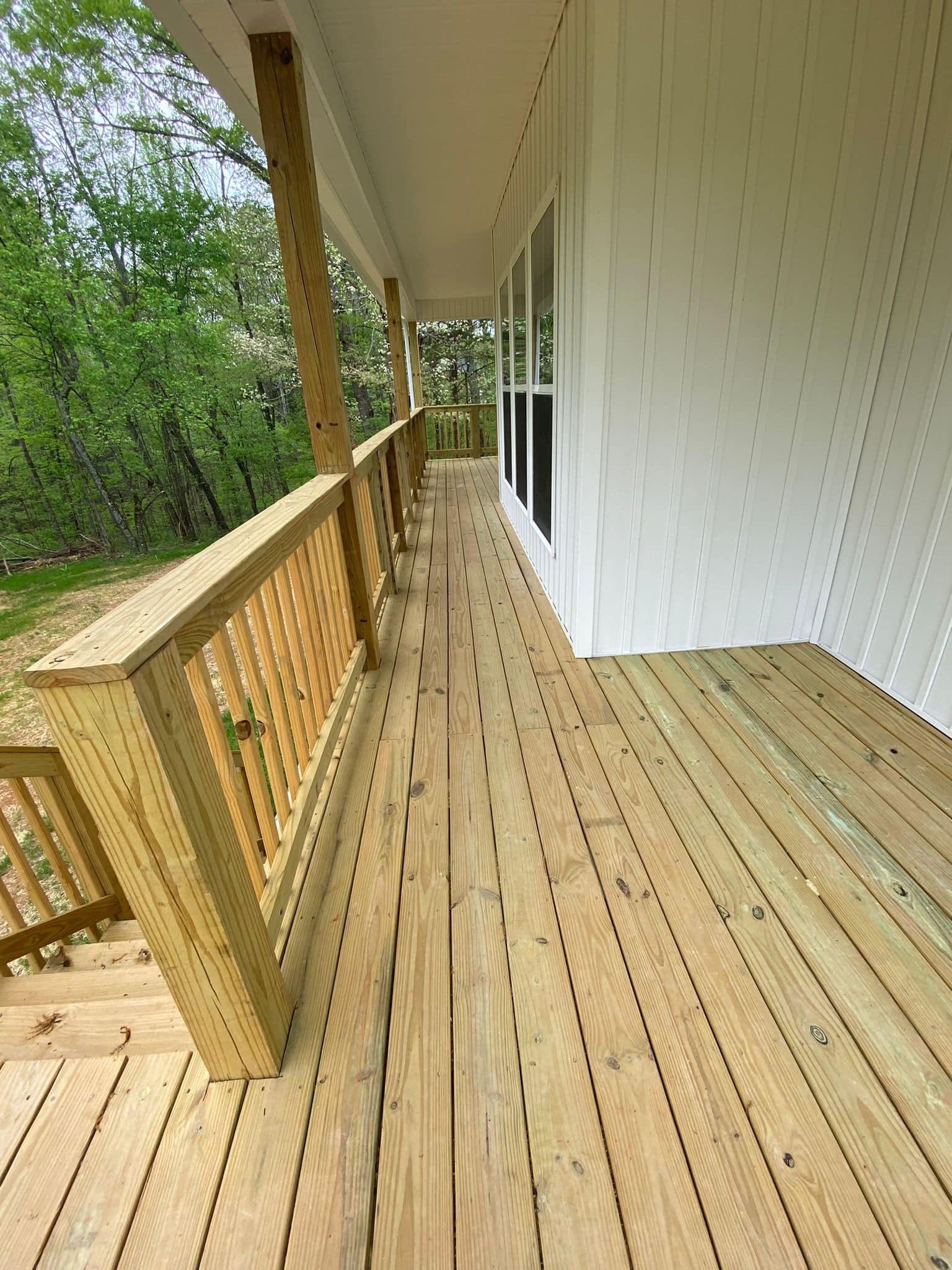 Covered wood porch with railing