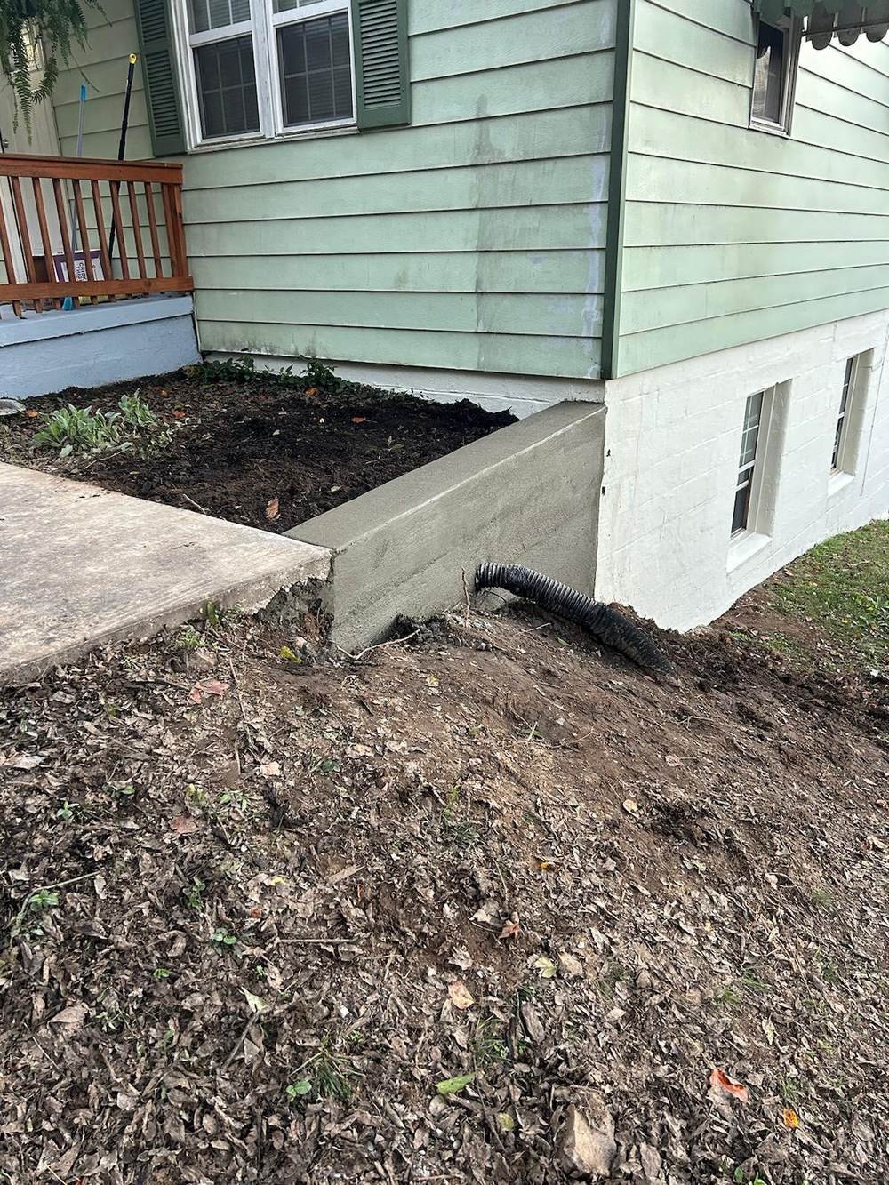 Concrete retaining wall at home foundation